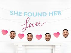 the man is standing in front of a wall with hearts on it that says she found her lover