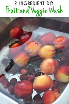 plums and cherries in a metal sink with text overlay that reads diy fruit & veggie wash