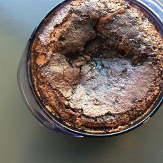 a chocolate cake in a plastic container on a table