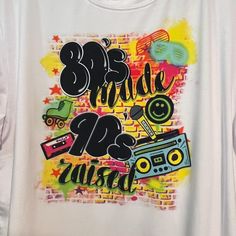 This purchase is for a white t-shirt with 80's made 90's raised on it. Thank you for ordering with me, I'm super excited to create your airbrush design & custom shirt  1. Choose your size  These are a fun old school throw back to the 90's and come in bright colors on a white t-shirt. Orders will be shipped UPS ground unless you've messaged me and arranged otherwise.  SHIPPING IS only in USA for airbrush t-shirts by making this purchase you understand that you will not be reimbursed if ordered by Airbrush Design, Back To The 90's, Airbrush T Shirts, Airbrush Designs, Custom Airbrushing, Graffiti Designs, Custom Shirt, Vintage Tee, Super Excited