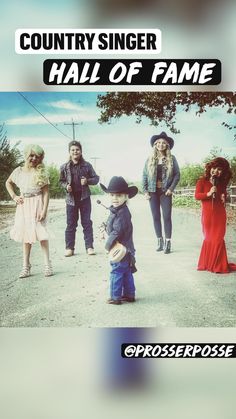 a group of people standing next to each other in front of a sign that says country singer hall of fame