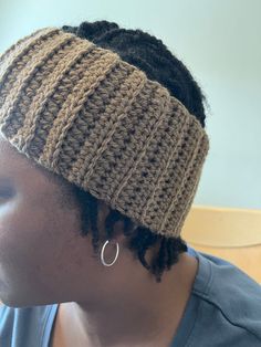 a close up of a person wearing a headband with dreadlocks on it