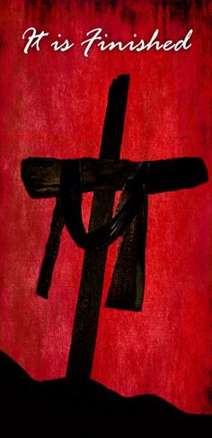 a cross with the words, it is finished on red and black paper in front of a