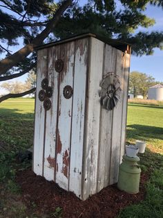 an old outhouse sits in the middle of a field