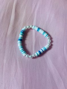 Ocean Blues is a bracelet that contains different shades of blue and white with pearls in different spots. It is the perfect bracelet to wear to the beach with the fam! Pearl Bracelet For Beach, Summer Beach Pearl Bracelet, Multicolor Pearl Bracelet For Summer Beach, Summer Pearl Beaded Bracelets For Beach, Blue Stretch Bracelet With Colorful Beads For Vacation, White Pearl Bracelet For Summer Beach, Blue Pearl Beaded Bracelets For Beach, Blue Round Beaded Bracelets For Summer, Blue Round Beads Bracelets For Summer