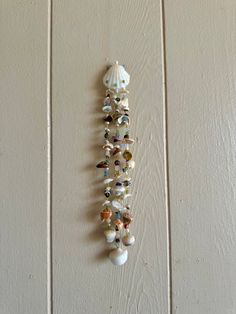 Three strands of gorgeous Hawaiian shells, glittering gemstones, perfect pearls and golden seed beads hang from a peridot embellished shell. All shells were hand picked from the pristine beaches on the North Shore of Oahu, or were gifted to me!  Rose quartz, prehnite lapis lazuli, amethyst, coral jasper, and many more crystals divide the shells and golden seed beads.  Using 20 lb. monofilament line to hang this piece of work, it's very sturdy and can be hung anywhere for a reminder of our beauti Perfect Pearls, Shell Mobile, European Summer, North Shore, Beautiful Islands, Simply Beautiful, Oahu, Hand Picked, Lapis Lazuli