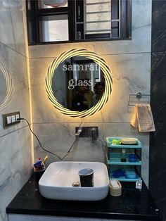 a bathroom with a sink, mirror and soap dispenser