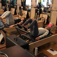 some people are doing exercises on rowing machines