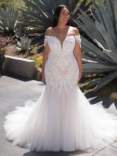 a woman in a wedding dress standing outside