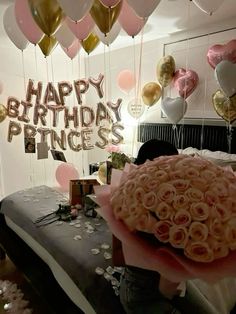 a room filled with balloons and pink roses