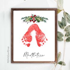 a christmas card with an image of a handprinted mitt and holly leaves