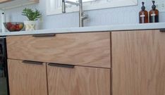 a kitchen with wooden cabinets and white counter tops