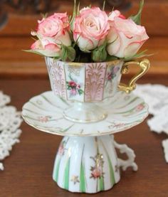 pink roses in a teacup on a stand