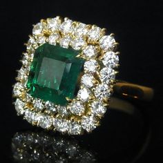 LAYAWAY PLANS AVAILABLE PLEASE CONTACT US FOR DETAILS  Style: You are looking at a custom made stunning  Emerald and Diamonds cocktail ring.  The ring features a beautiful 1.8ct Zambian Emerald surrounded by  1.95ct of VS clarity Diamonds.   The emerald shows incredible color.  The setting is 18K solid yellow gold.  Size of the ring is impressive with front measuring  approximately 1.6cm x 1.6cm.  This ring can make an amazing engagement ring fit for royalty or just be a stunning cocktail piece. Bead Jewellery Making Ideas, Jewellery Making Ideas, Halo Engagement Ring Emerald, Inexpensive Jewelry, Silver Wrap Ring, Emerald Rings, Lace Ring, Book Jewelry, Gold Cocktail