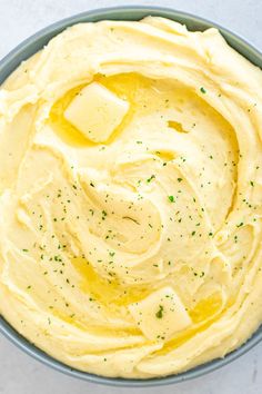 a bowl filled with mashed potatoes on top of a table