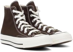 Converse.Brown Chuck 70 High Top Sneakers.High-top canvas sneakers in brown..· Rubber cap toe.· Lace-up closure.· Logo patch and eyelets at inner side.· Cushioned Ortholite® footbed.· Canvas lining.· Rubberized logo patch at midsole.· Treaded rubber sole.· Contrast stitching in white.Supplier color: Dark root/Egret/Black.Upper: textile. Sole: rubber..Made in Viet Nam..241799M236065 Brown Chuck 70, Chuck 70 High Top, Converse Brown, Chuck 70, Converse Sneakers, Mens Sportswear, Sneaker Collection, Canvas Sneakers, Contrast Stitch