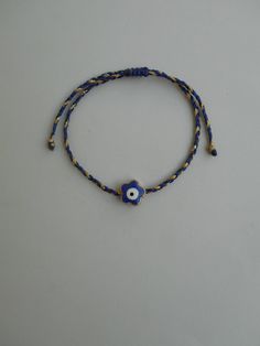 "Flower evil eye bracelet, Evil eye flower, Evil Eye, Flower Evil Eye, Blue daisy, evil eye charms, blue evil eye charm, daisy evil eye charm, gold evil eye charm You can select a total blue braided bracelet or a blue with a pinch of gold braided bracelet from the drop-down options. This simple yet beautiful bracelet is made using durable golden waxed string and has an enameled flower evil eye gold tone charm in the middle. It is adjustable with a sliding knot closure. The price is for 1 bracele Evil Eye Flower, Eye Flower, Eye Charm Bracelet, Charm Bracelet Gold, Bracelet Evil Eye, Enamel Beads, Gold Charms, Gold Charm Bracelet, Unisex Gift