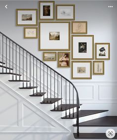 there is a staircase with pictures on the wall