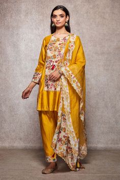 Mustard kurta with all-over floral embroidery and round neck. Comes with salwar and embroidered dupatta.
Component: 3
Embroidered
Neckline: Round
Sleeve Length: Full
Fabric: Cotton, Kota Doria
Color: Yellow
Embroidery at the sleeves and hem of the salwar
Straight fit kurta
Tie-up at the neck with tassels
Scallop hem dupatta
Tassels on the dupatta - Aza Fashions Dupatta Tassels, Yellow Embroidery, Kurta Set For Women, Embroidered Dupatta, Scallop Hem, Embroidered Neckline, Fashion App, Kurta Set, Scalloped Hem