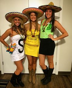 three women dressed in costumes and hats posing for the camera with their hands on their hipss