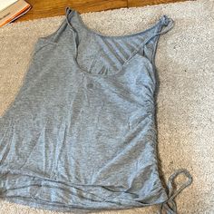 Grey Scrunched Lulu Lemon Tank Top Very Cute Never Worn Spring Workout Ruched Tops, Casual Drawstring Workout Tops, Ruched Tops For Summer Workouts, Casual Sleeveless Top With Ruched Sides, Spring Workout Tops With Drawstring, Casual Ruched Stretch Tank Top, Casual Stretch Ruched Tank Top, Casual Ruched Back Top For Spring, Lulu Lemon