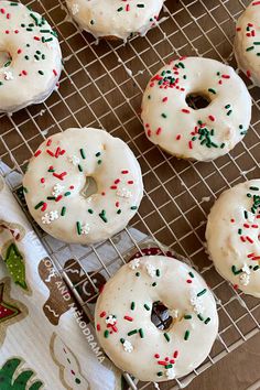 homemade eggnog donuts with white frosting and sprinkles on a cooling rack