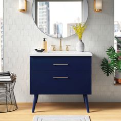 a bathroom with a blue vanity and mirror