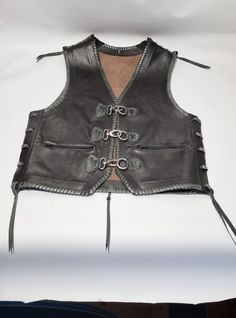 "This vest is suitable for anyone who wants to stand out from the crowd. Motorcyclists are excited and satisfied. Most of them are sewn with sequins from moto choirs. The vest is handmade from extremely high quality leather and has a beautiful braid at the edges. Completely comfortable and easy to carry. Inside, there are 2 large pockets on each side. They are very enthusiastic about our work. The most important thing for us is to satisfy our customers. If you have any questions about my product Brown Biker Vest For Events, Brown Biker Vest For Biker Events, Black Biker Vest For Festivals, Biker Style Fitted Vest For Festivals, Fitted Biker Vest For Festivals, Winter Leather Vest For Biker Events, Leather Biker Vest For Winter, Festival Biker Jacket, Punk Style Winter Vest For Biker Events