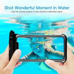 someone taking a photo with their cell phone in front of the camera while swimming under water