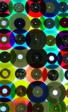 many different colored records are arranged together