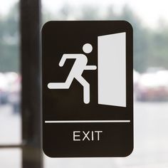 an exit sign is shown in front of a window with the door open to let people know