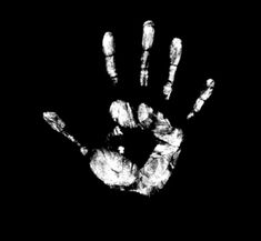 a black and white hand print on a dark background