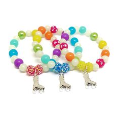 These adorable bracelets are the perfect addition to your little one's Skating party! Each bracelet features a Tibetan silver charm, resin rhinestone beads, an assortment of bright rainbow 10mm acrylic beads and 8mm glow in the dark beads strung with durable stretch floss cord. Stretch floss cord does not lose it's elasticity like the plastic type of stretch cord does so your little one and her friends will be proud to wear and show off their beautiful bracelets long after the party. Each bracel Novelty Beaded Bracelets For Birthday, Novelty Beaded Bracelets For Birthdays, White Charms Bracelets For Birthday Gift, Playful Jewelry With Charms And Round Beads, Playful Jewelry With Round Beads And Charms, Playful Jewelry With Round Bead Charms, Silver Novelty Charm Bracelet For Birthday, Multicolor Charms Jewelry For Birthday, Multicolor Charm Jewelry For Birthday