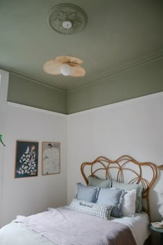 a bed sitting in a bedroom under a ceiling fan