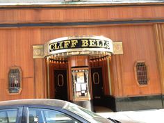 a car parked in front of a building with a sign that says cliffe bells