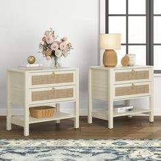 two white nightstands with baskets and flowers on them