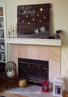 a fire place with a christmas sign above it