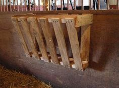 the inside of a stable with wooden slats