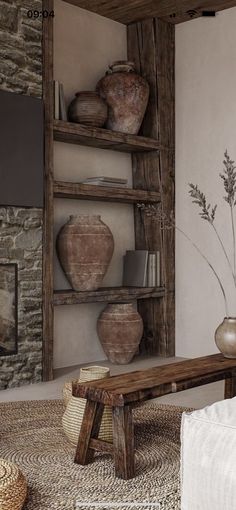 a living room filled with furniture next to a fire place and wall mounted tv on top of a wooden shelf