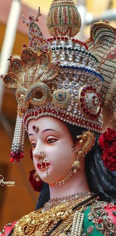 a close up of a statue with jewelry on it's head