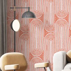 a living room with two chairs and a lamp next to a wall that has an art deco pattern on it