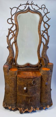 an ornate wooden dresser with mirror on top