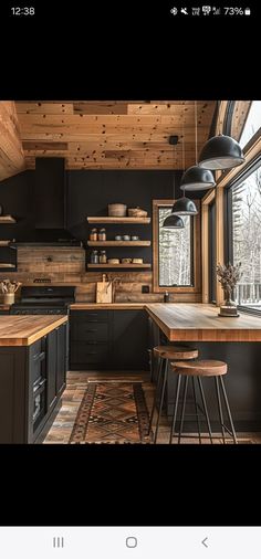 an image of a kitchen with black cabinets and counter tops in the middle of it