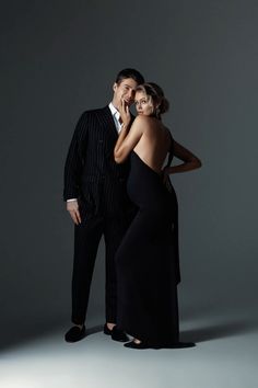 a man in a suit and woman in a black dress