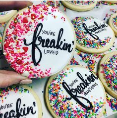 someone holding up some decorated cookies with the words you're freakin loved