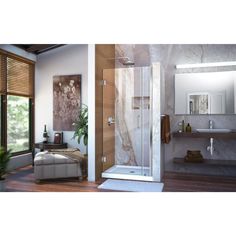 a bathroom with a walk in shower next to a sink and mirror on the wall