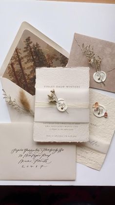 the wedding stationery is laid out on top of each other