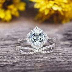 a white gold ring with an aqua blue topazte surrounded by diamonds