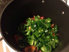 green peppers are being cooked in a pan on the stove