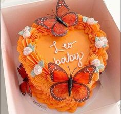 a birthday cake decorated with butterflies in a box